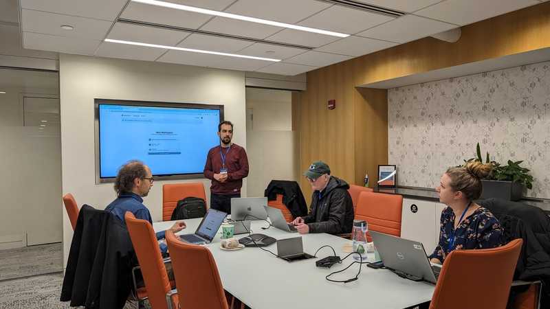 Ashraf Abed in a conference room leading a presentation on Drupal.